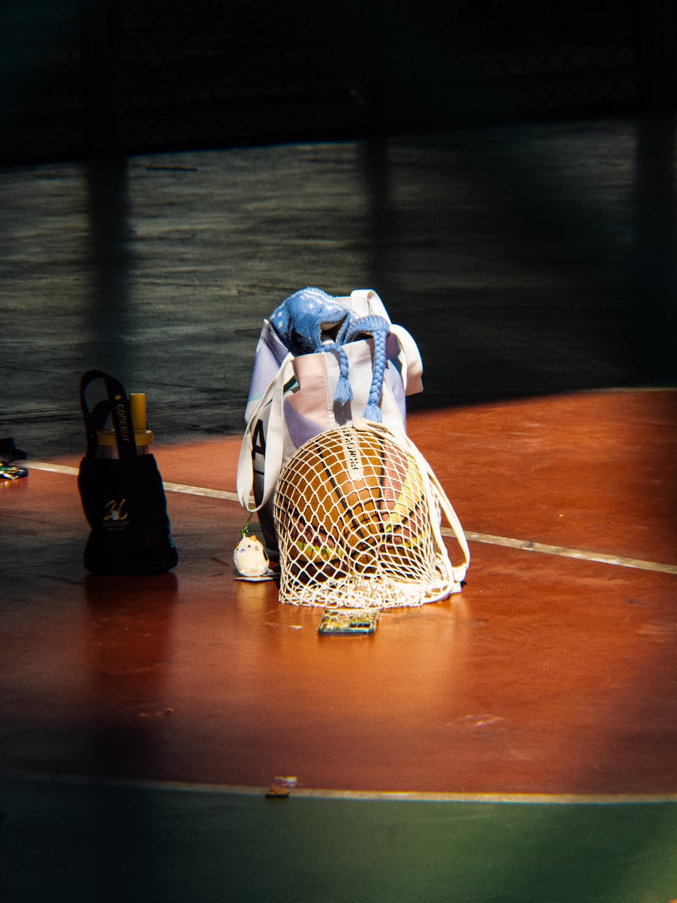 basketball and sports gear on court