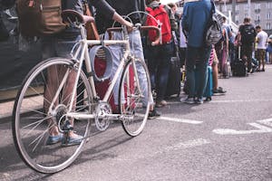 A diverse group of adults lined up in a city street, showcasing urban life.