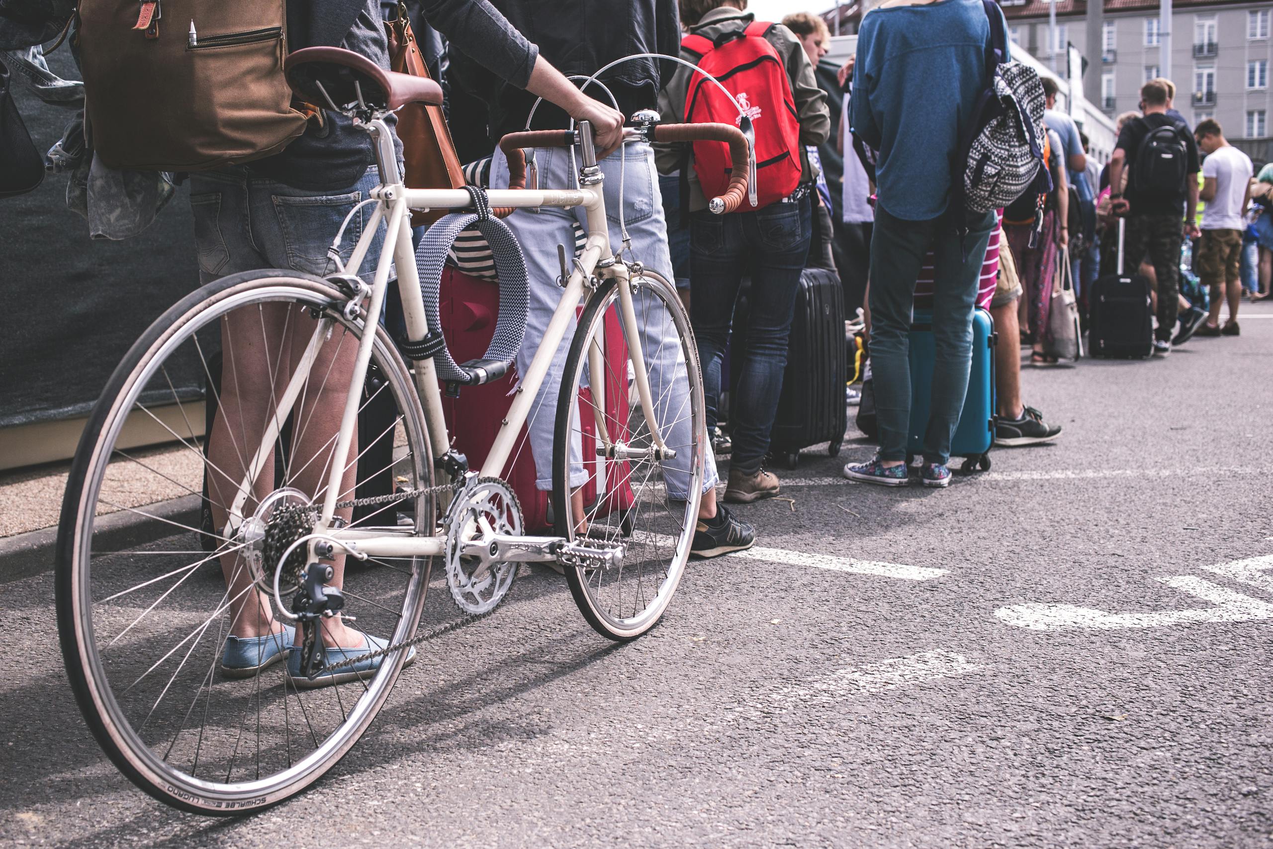 A diverse group of adults lined up in a city street, showcasing urban life.