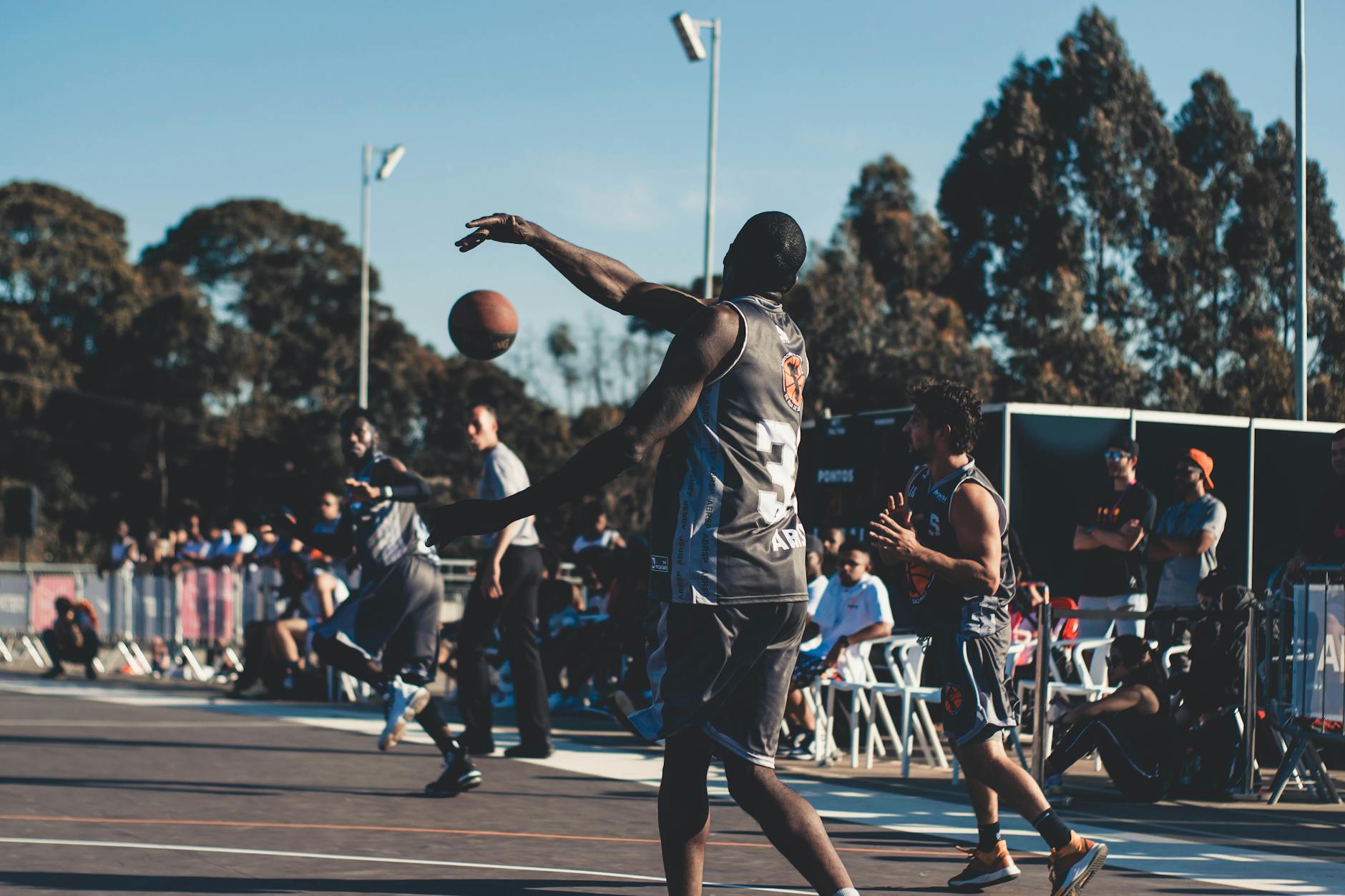 men playing basketball on open court